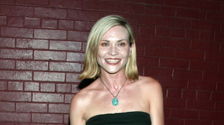 amy locane smiling red brick