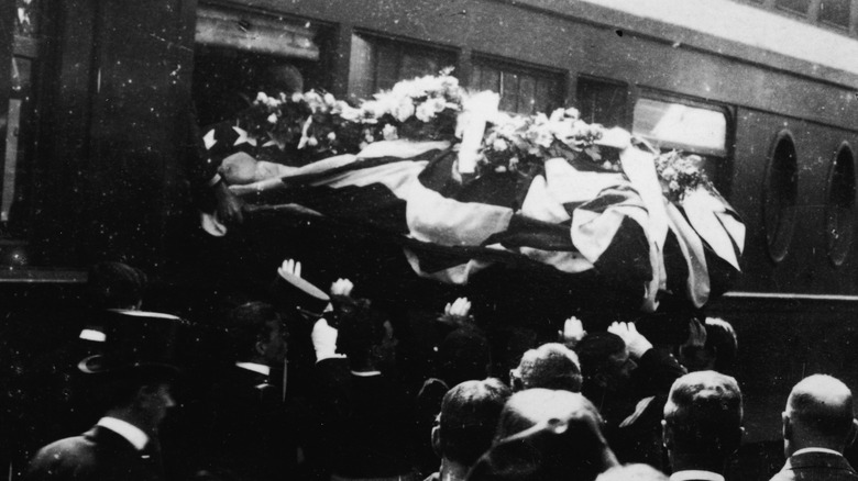 Old photo of coffin carried onto train