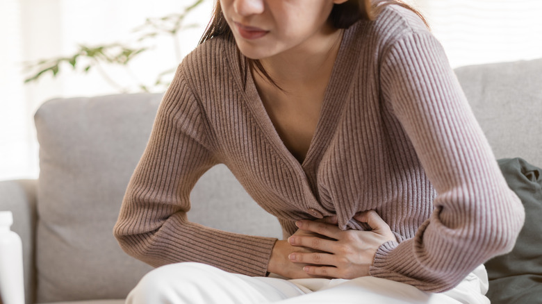 Woman grabbing her stomach