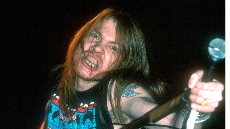 Axl Rose holding microphone clenching teeth