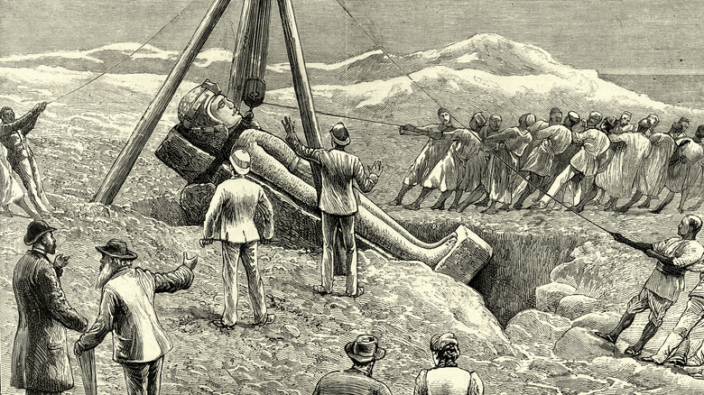 Victorian engraving of archeologists hauling up statue 