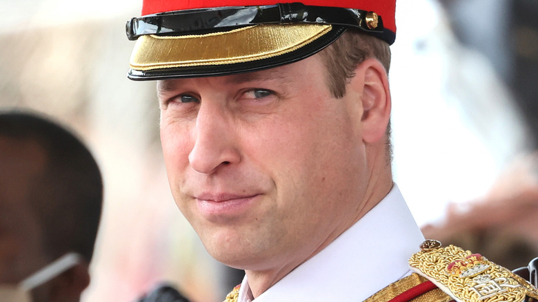 Prince William drives through Jamaica in full uniform