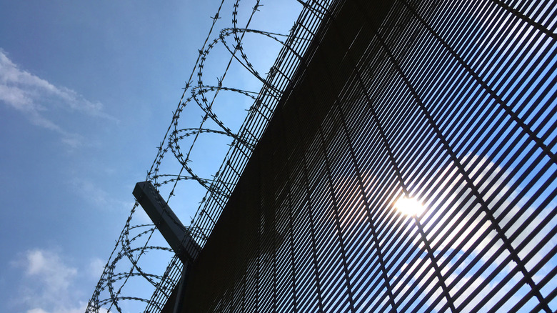 blue sky with a prison fence