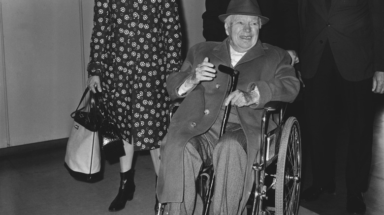 Charlie Chaplin in wheelchair smiling hat