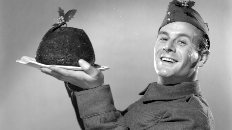 british military man holding a christmas pudding