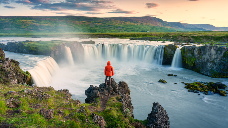 person by a waterfall in Iceland