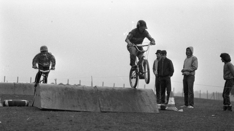 Racers on BMX going over a jump