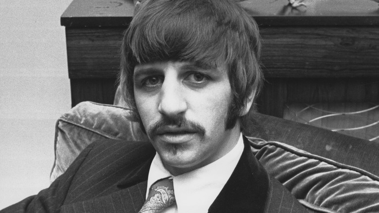 Ringo Starr sitting in velvet chair