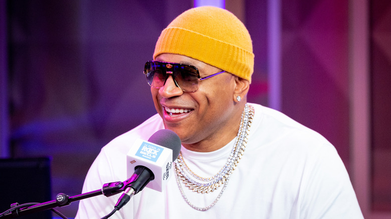 LL Cool J yellow beanie sunglasses mic talking