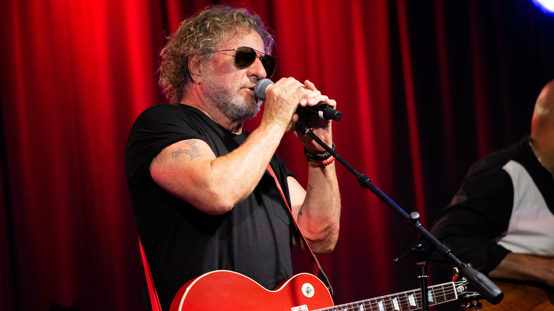 Sammy Hagar sunglasses singing into microphone