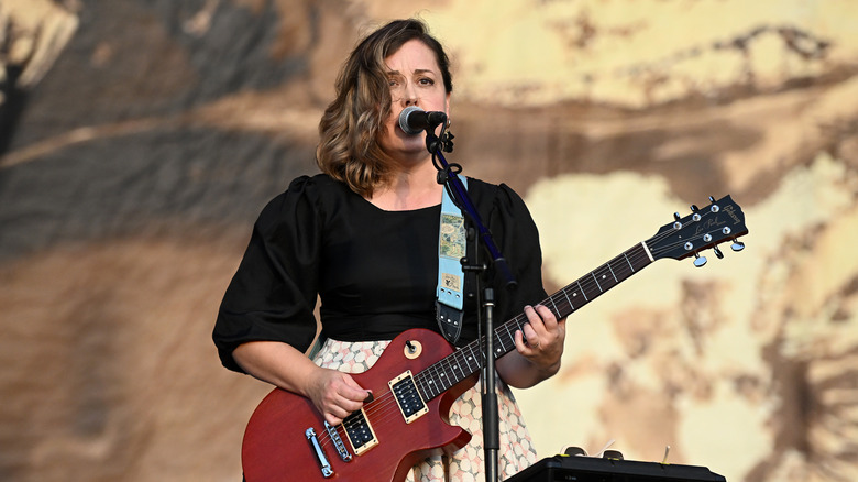 Corin Tucker singing into microphone