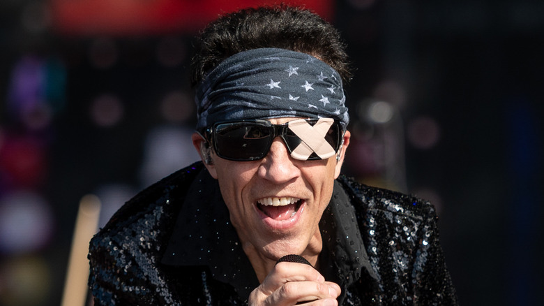 gary cherone performing with extreme in 2024 in bandana and sunglasses with X on them