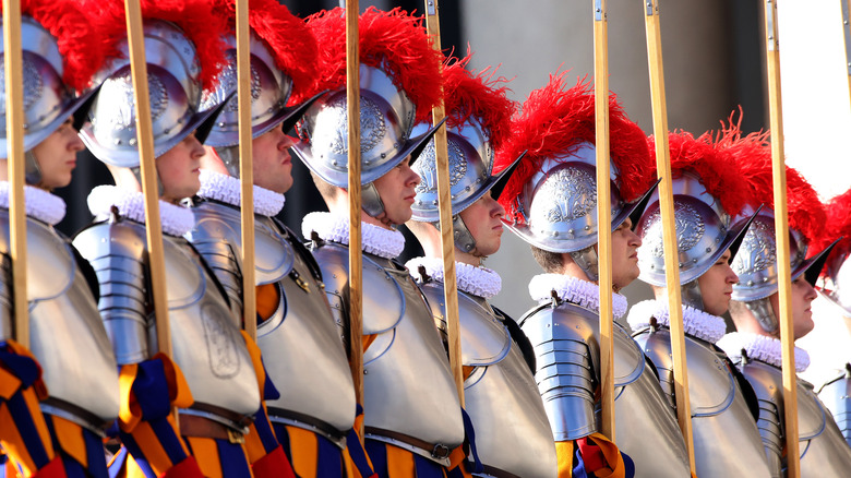 Swiss guards stand at attention red crested armor