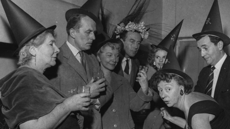 Actors at an adult Halloween party in 1958, black and white