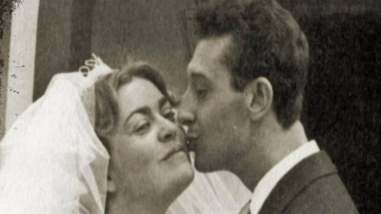 Anna Maria being kissed by husband