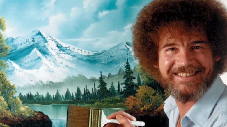 Bob Ross in front of landscape painting