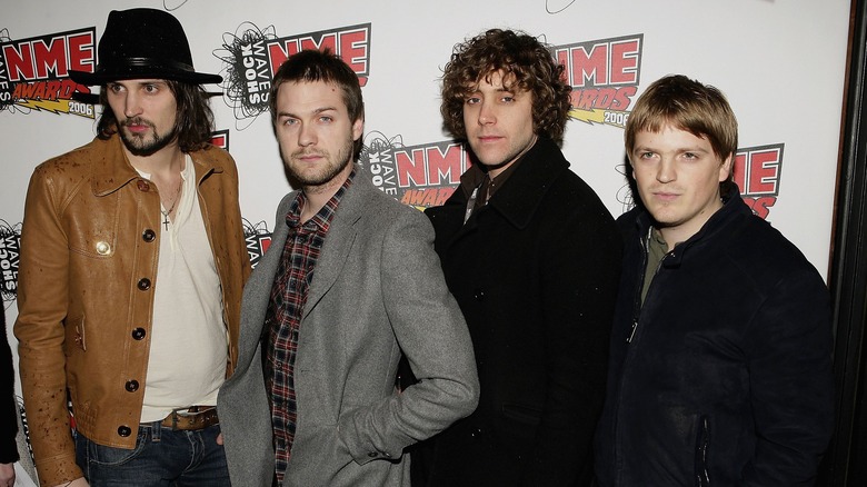 Kasabian band members posing for photograph