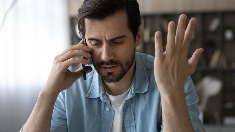 frustrated man on phone