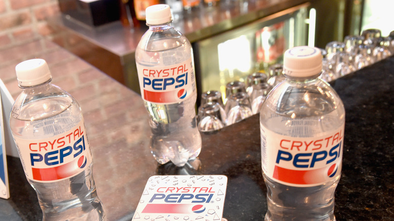 Bottles of Crystal Pepsi on a bar