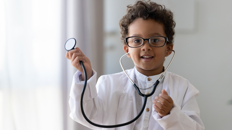 a young child in a doctor's uniform