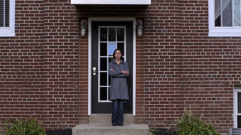 Alex Miller standing outside apartment