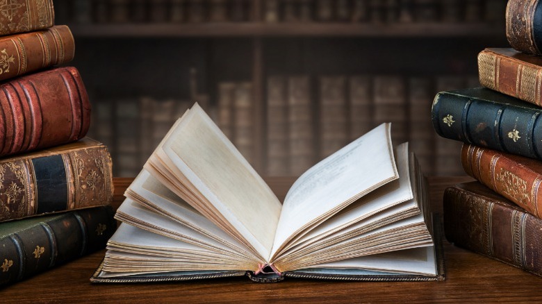 open book between stacks of books