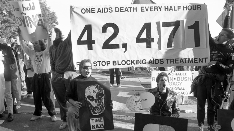 AIDs policy protestors with banners