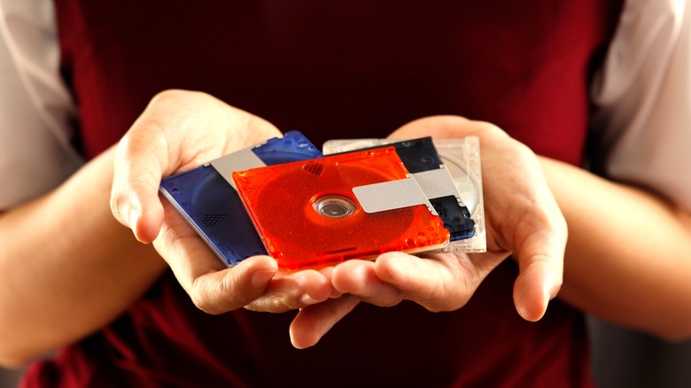 Hands holding MiniDiscs