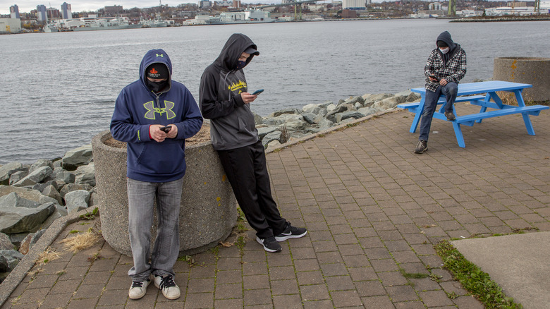 People with face masks playing Pokemon Go