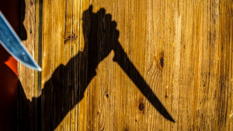 shadow of man with knife