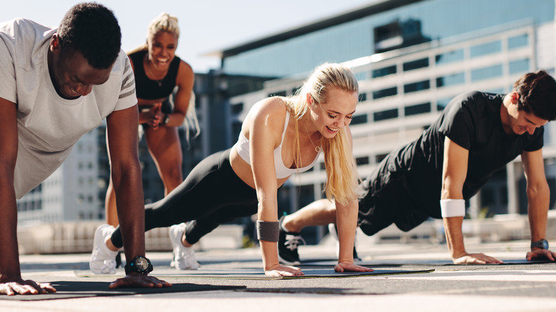 Three people doing push ups