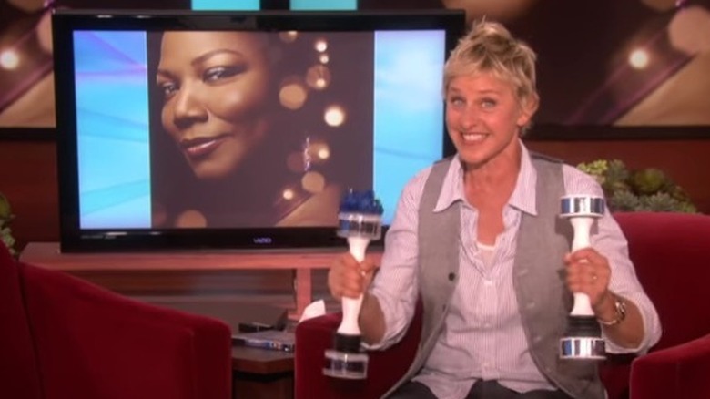 Ellen DeGeneres holding two Shake Weights