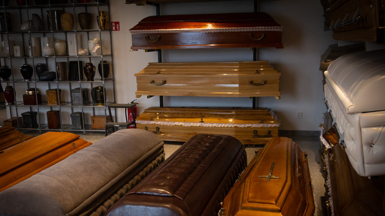 Funeral home interior with caskets and urns