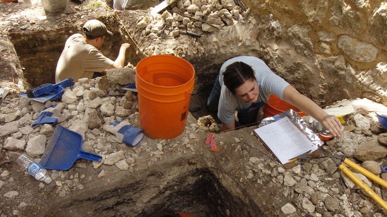 Archaeologists and students excavating north wall of Alamo barracks