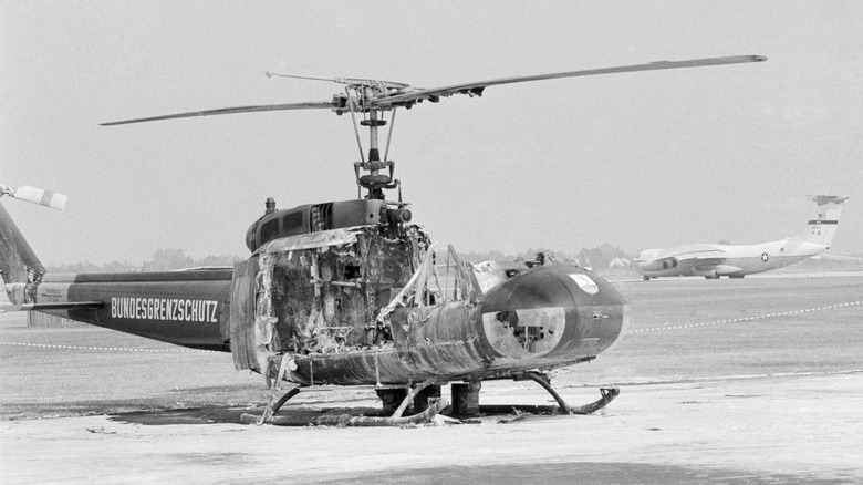 Burnt helicopter on airport tarmac