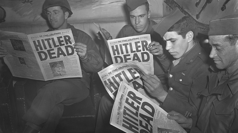 Soldiers read about Hitler's death