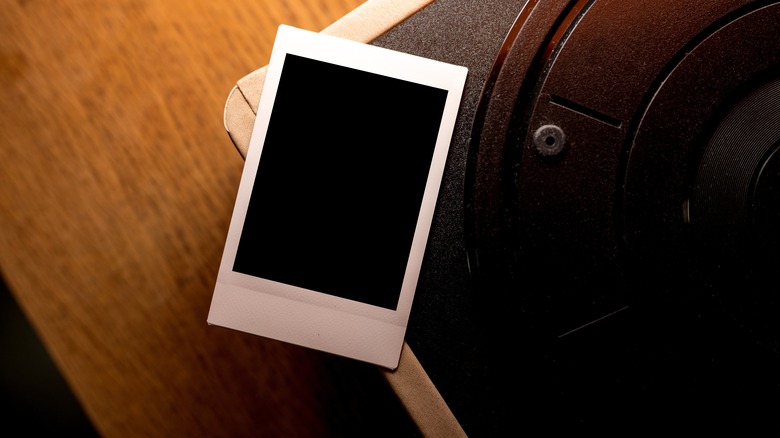 Polaroid photo fram on a wooden table