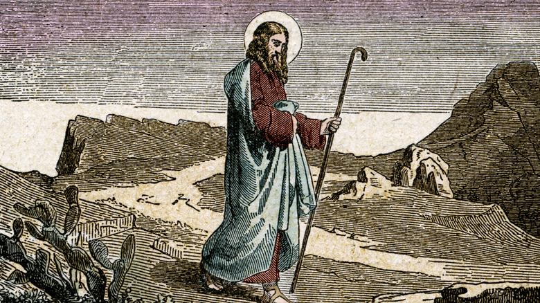 St. Matthias walking in desert with staff in white cloak