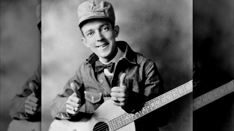 Jimmie Rodgers smiling thumbs up guitar