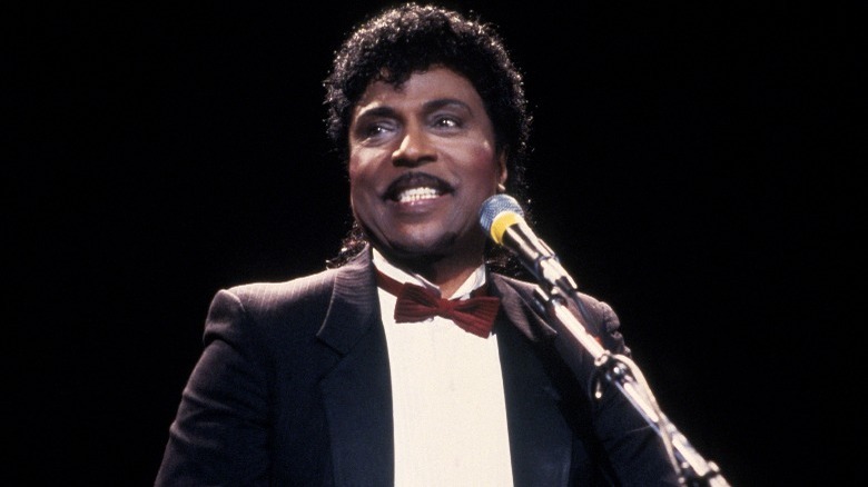 Little Richard giving speech onstage red bowtie