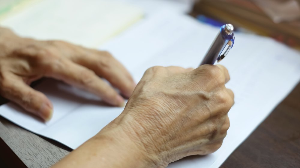 Woman writing on notepad