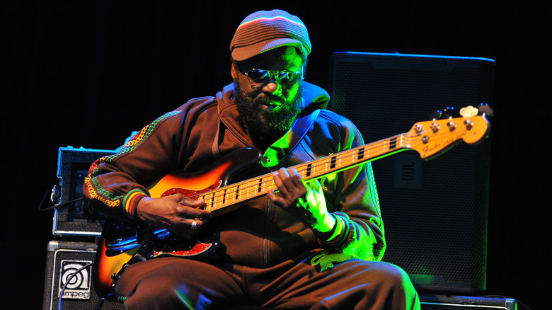 Aston Barrett playing bass onstage in sunglasses