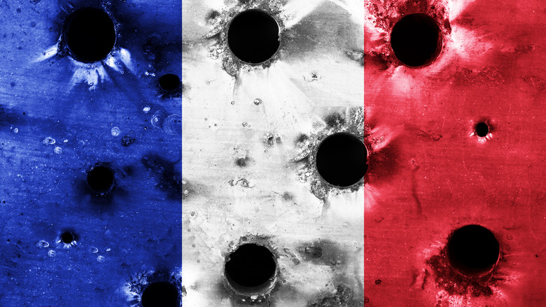 metallic French flag with bullet holes