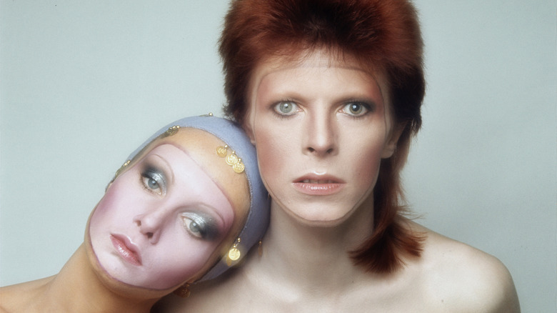 Twiggy resting head on David Bowie's shoulder