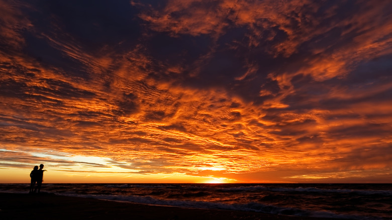 Two people silhouetted against sunset