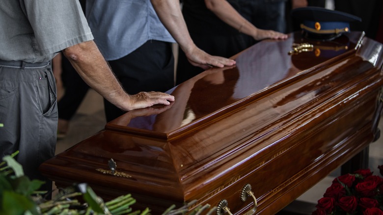 mourners and a coffin