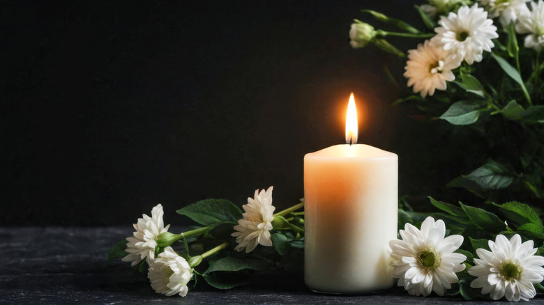 Funereal flowers and candle