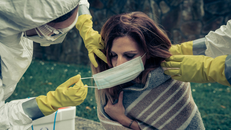 Distressed woman treated by workers