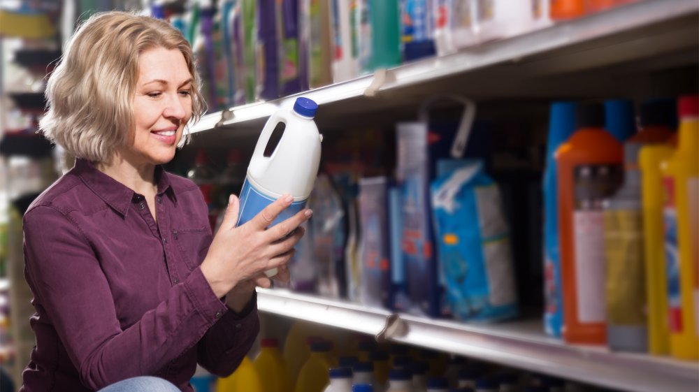 woman holding household cleaner container