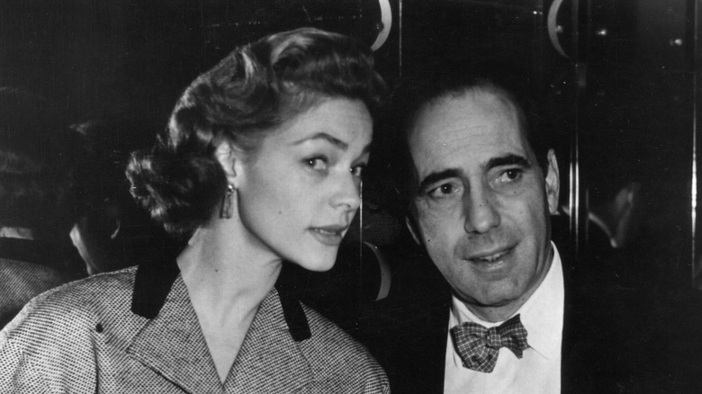 Bogart and Bacall appraising something off-camera